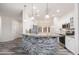Modern kitchen with granite countertops, stainless steel appliances, and white cabinets at 15583 W Big Sky Dr, Surprise, AZ 85374