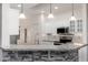 Modern kitchen with granite countertops, stainless steel appliances, and white cabinets at 15583 W Big Sky Dr, Surprise, AZ 85374