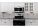Modern kitchen with granite countertops and stainless steel appliances at 15583 W Big Sky Dr, Surprise, AZ 85374