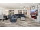 Spacious living room featuring a sectional sofa and built-in entertainment center at 15583 W Big Sky Dr, Surprise, AZ 85374
