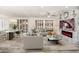 Open living area with sectional sofa, fireplace, and large TV at 15583 W Big Sky Dr, Surprise, AZ 85374