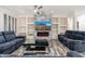 Comfortable living room, featuring a sectional sofa and a modern fireplace at 15583 W Big Sky Dr, Surprise, AZ 85374
