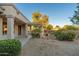 Landscaped patio area with a pergola and stone accents at 15583 W Big Sky Dr, Surprise, AZ 85374