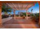 Covered patio with pergola, string lights, and desert plants at 15583 W Big Sky Dr, Surprise, AZ 85374