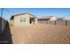 Spacious backyard with gravel landscaping and a view of the home's back at 19959 W Rancho Dr, Litchfield Park, AZ 85340