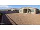 Large backyard with gravel and a partial view of neighboring homes at 19959 W Rancho Dr, Litchfield Park, AZ 85340