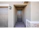 Front entry with a dark wood door and stone accent wall at 19959 W Rancho Dr, Litchfield Park, AZ 85340