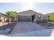House exterior showcasing a two-car garage and well-maintained landscaping at 19959 W Rancho Dr, Litchfield Park, AZ 85340
