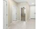 Bright hallway with tile floors and access to various rooms at 19959 W Rancho Dr, Litchfield Park, AZ 85340