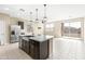 Open kitchen with island, stainless steel appliances, and access to backyard at 19959 W Rancho Dr, Litchfield Park, AZ 85340