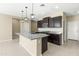 Modern kitchen features granite countertops and dark wood cabinets at 19959 W Rancho Dr, Litchfield Park, AZ 85340