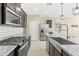 Stainless steel appliances and a farmhouse sink in a modern kitchen at 19959 W Rancho Dr, Litchfield Park, AZ 85340