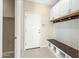 Convenient laundry room with built-in bench and storage at 19959 W Rancho Dr, Litchfield Park, AZ 85340