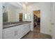 Double vanity bathroom with granite countertops and walk-in closet at 20487 W Minnezona Ave, Buckeye, AZ 85396