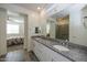 Double vanity bathroom with granite countertops and a walk-in shower at 20487 W Minnezona Ave, Buckeye, AZ 85396