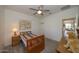 Cozy bedroom featuring a ceiling fan and striped bedding at 20487 W Minnezona Ave, Buckeye, AZ 85396