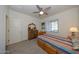 Bright bedroom with wood furniture and ceiling fan at 20487 W Minnezona Ave, Buckeye, AZ 85396