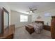 Spacious bedroom with ceiling fan and carpeted floors at 20487 W Minnezona Ave, Buckeye, AZ 85396