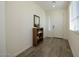 Bright entryway with tile flooring and a wooden shelving unit at 20487 W Minnezona Ave, Buckeye, AZ 85396