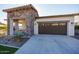 Single-story home with stone accents and a two-car garage at 20487 W Minnezona Ave, Buckeye, AZ 85396