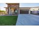 Front view of house with stone facade and artificial turf at 20487 W Minnezona Ave, Buckeye, AZ 85396