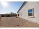 Side view of house showcasing desert landscaping and gravel at 20487 W Minnezona Ave, Buckeye, AZ 85396