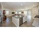 Open kitchen with island, stainless steel appliances, and granite countertops at 20487 W Minnezona Ave, Buckeye, AZ 85396