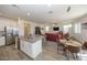Open kitchen with island, stainless steel appliances, and granite countertops at 20487 W Minnezona Ave, Buckeye, AZ 85396