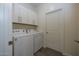 Convenient laundry room with washer, dryer, and cabinets at 20487 W Minnezona Ave, Buckeye, AZ 85396