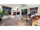 Living room with fireplace, leather furniture, and a ceiling fan at 20933 N 70Th Dr, Glendale, AZ 85308