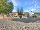 Backyard view of house with gravel, a white fence and desert landscape at 21603 N Yellowstone Ct, Sun City West, AZ 85375