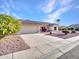 Front view of a single-story house with a driveway and desert landscaping at 21603 N Yellowstone Ct, Sun City West, AZ 85375