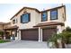 Two-story house with a three-car garage and palm trees at 25320 N 52Nd Ave, Phoenix, AZ 85083