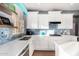 Bright kitchen with white cabinets, blue tile backsplash, and quartz countertops at 25320 N 52Nd Ave, Phoenix, AZ 85083