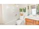 Clean bathroom with a shower/tub combo and wood vanity at 25564 W Ripple Rd, Buckeye, AZ 85326