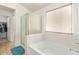 Bathroom with shower, bathtub, and walk-in closet at 25564 W Ripple Rd, Buckeye, AZ 85326