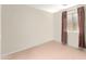 Spacious bedroom with neutral walls and carpeting, featuring a window with curtains at 25564 W Ripple Rd, Buckeye, AZ 85326