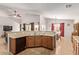 Spacious kitchen with light wood cabinets and a breakfast bar at 25564 W Ripple Rd, Buckeye, AZ 85326