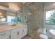 Spa-like bathroom featuring marble walk-in shower, white cabinets, and garden tub at 36925 N Stoneware Dr, Queen Creek, AZ 85140