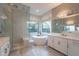 Spa-like bathroom with a standalone tub, a glass enclosed shower, and marble countertops at 36925 N Stoneware Dr, Queen Creek, AZ 85140