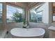 Bright bathroom with freestanding tub overlooking the fenced backyard and landscaping at 36925 N Stoneware Dr, Queen Creek, AZ 85140