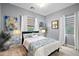 Guest bedroom with a queen bed, stylish decor, and plenty of natural light at 36925 N Stoneware Dr, Queen Creek, AZ 85140