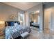 Cozy bedroom with a blue patterned bedspread, mirror closet doors, and ample natural light at 36925 N Stoneware Dr, Queen Creek, AZ 85140