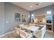 Modern dining area with bench seating, built-in shelving, and neutral color palette at 36925 N Stoneware Dr, Queen Creek, AZ 85140