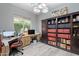 This home office features built-in bookshelves, a large window, and plenty of workspace at 36925 N Stoneware Dr, Queen Creek, AZ 85140