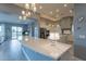 Open kitchen featuring a large island, modern lighting, and stainless steel appliances at 36925 N Stoneware Dr, Queen Creek, AZ 85140