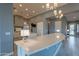 Spacious kitchen with a large island, modern lighting, stainless steel appliances, and stone countertops at 36925 N Stoneware Dr, Queen Creek, AZ 85140