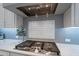 A gourmet kitchen featuring gas cooktop, designer backsplash, and spacious countertops, perfect for culinary enthusiasts at 36925 N Stoneware Dr, Queen Creek, AZ 85140