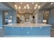 This spacious kitchen features pendant lighting, large island, stainless appliances and a breakfast bar at 36925 N Stoneware Dr, Queen Creek, AZ 85140
