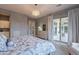Serene bedroom featuring a walkout to the patio, neutral tones, and a stylish chandelier at 36925 N Stoneware Dr, Queen Creek, AZ 85140